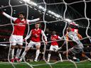 Arsenal stroll into semis