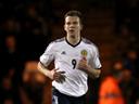 Rhodes double helps Scotland scrape win