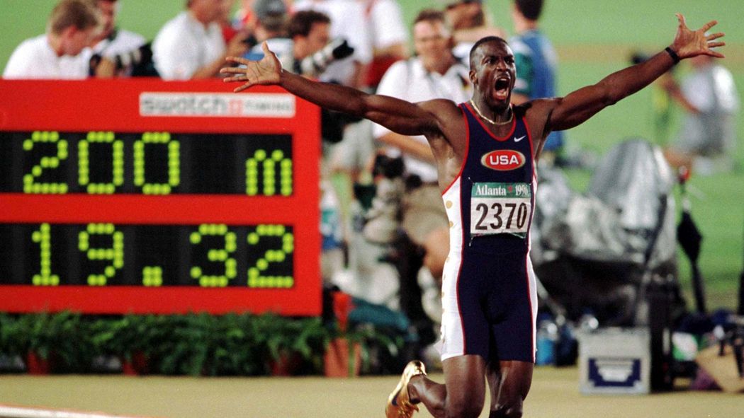 Michael Johnson celebrates his world record time in the 200m