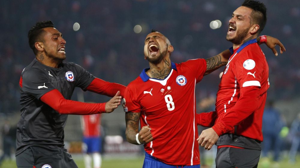 Chile's Arturo Vidal (8) celebrates with team-mates after defeating Argentina to win the Copa America