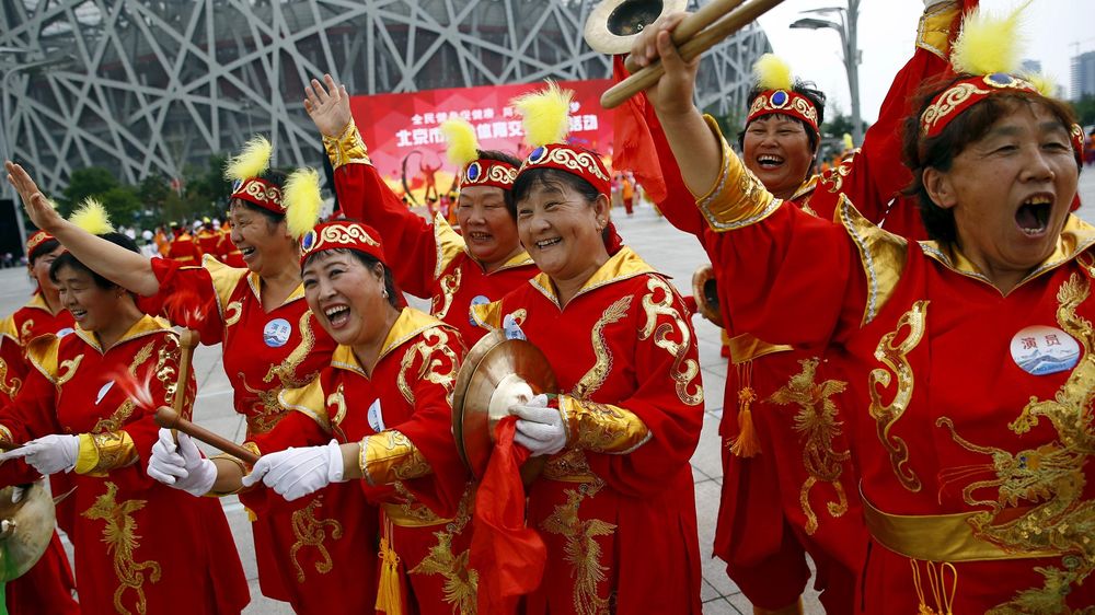 Performers cheer in Beijing ahead of the IOC's announcement of the winning city for the 2022 Winter Olympics bid