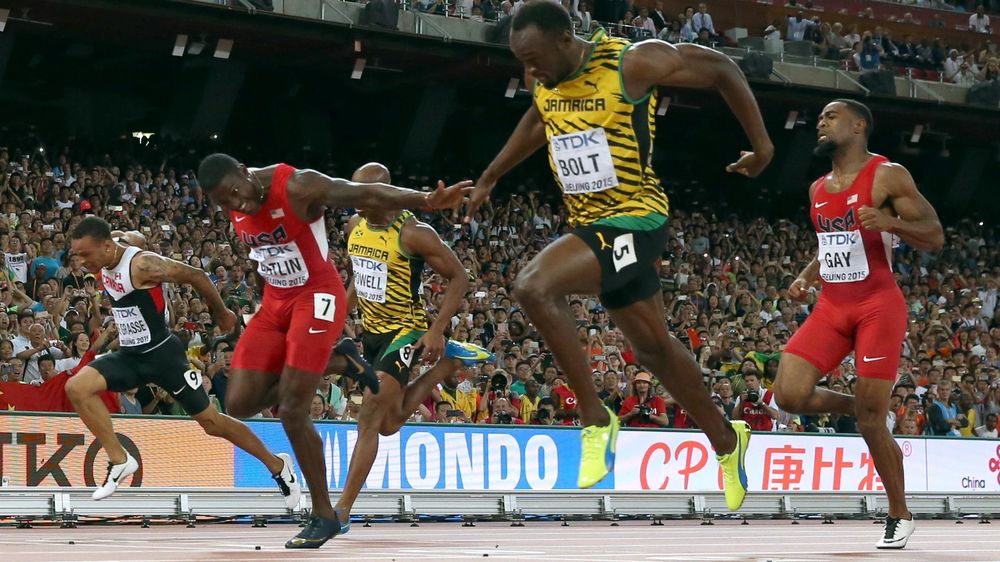 Usain Bolt of Jamaica (2nd R) crosses the finsih line ahead of Justin Gatlin of the U.S. (2nd L) to win the men's 100 metres final during the 15th IAAF World Championships at the National Stadium in Beijing, China August 23, 2015.