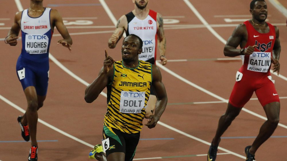 Usain Bolt Jamaica (bottom) celebrates winning the race ahead of Justin Gatlin of U.S. (R) who finished in second and Zharnel Hughes of Great Britain in the men's 200 metres final during the 15th IAAF World Championships at the National Stadium in Beijing