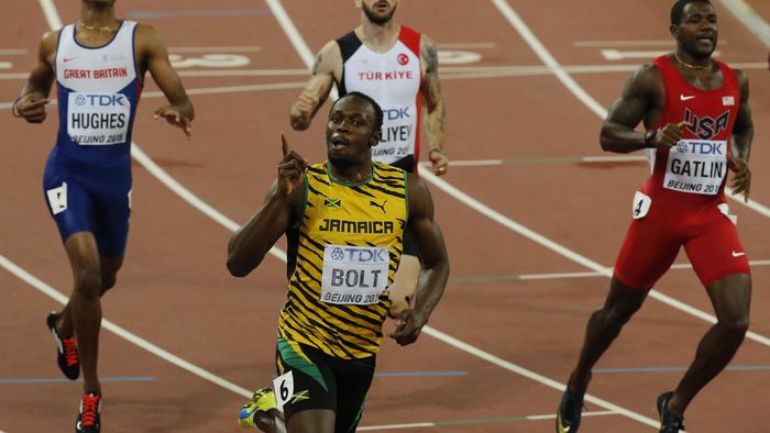 Usain Bolt Jamaica (bottom) celebrates winning the race ahead of Justin Gatlin of U.S. (R) who finished in second and Zharnel Hughes of Great Britain in the men's 200 metres final during the 15th IAAF World Championships at the National Stadium in Beijing
