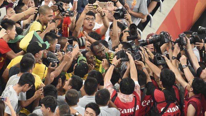 Jamaica's Usain Bolt (C) celebrates with fans after winning the final of the men's 200 metres athletics event at the 2015 IAAF World Championships at the "Bird's Nest" National Stadium in Beijing on August 27, 2015