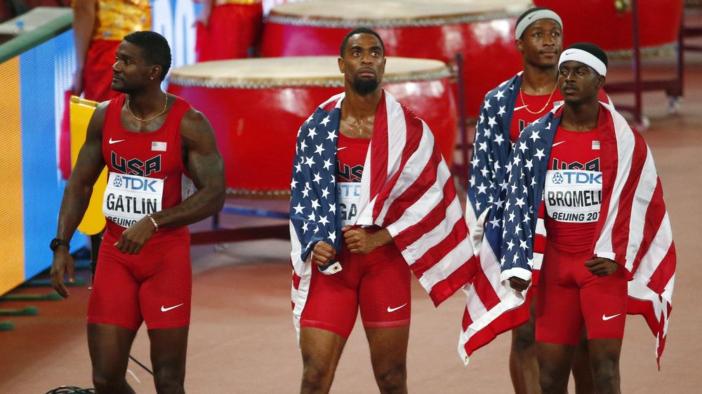 Tyson Gay of the U.S. (2ndL) reacts after being disqualified next to his teammates Justlin Gatlin (L), Mike Rodgers (2ndR) and Trayvon Bromell in the men's 4 x 100 metres relay final during the 15th IAAF Championships at the National Stadium in Beijing, C