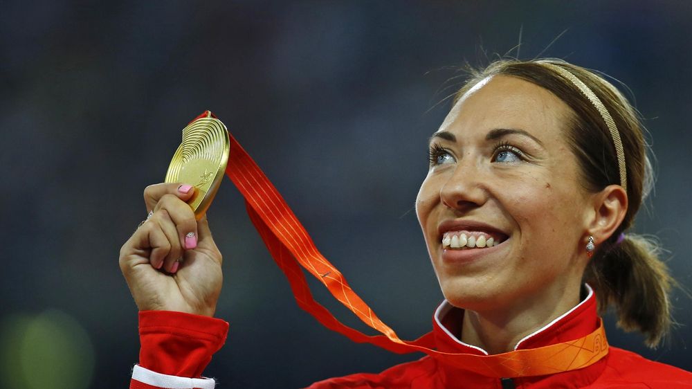 Marina Arzamasova looks to her gold medal.