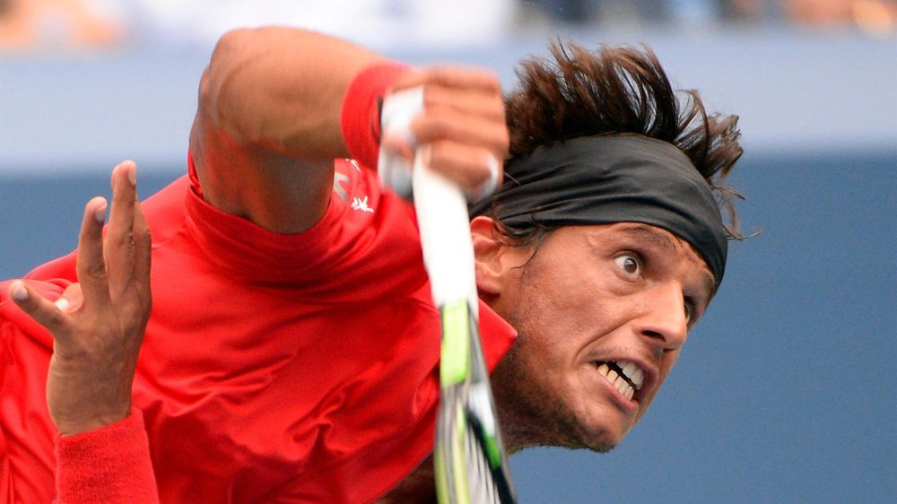 Joao Souza of Brazil serves to Novak Djokovic of Serbia on day one of the 2015 US Open at USTA Billie Jean King National Tennis Center. USA TODAY Sports