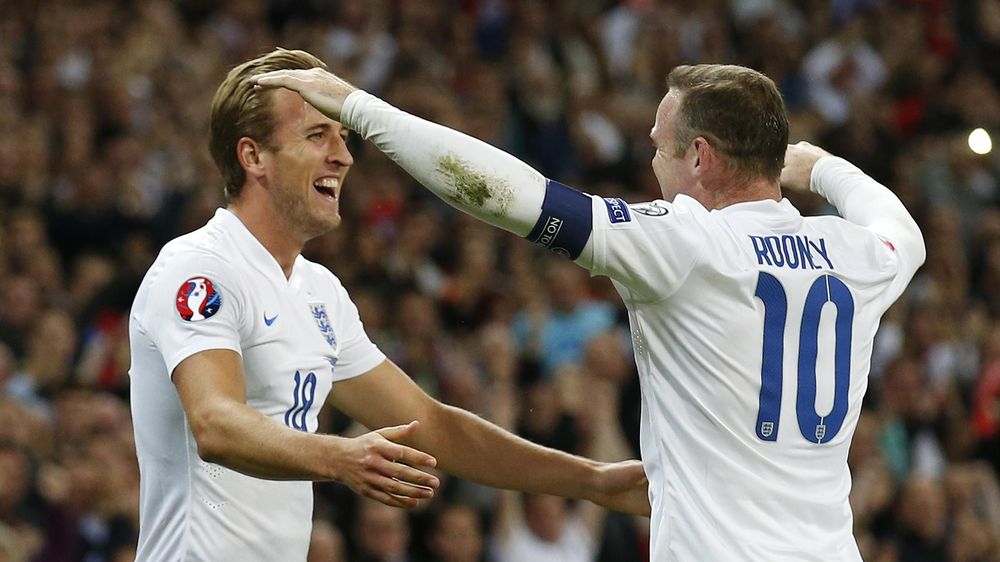 Harry Kane celebrates with Wayne Rooney after scoring the first goal for England