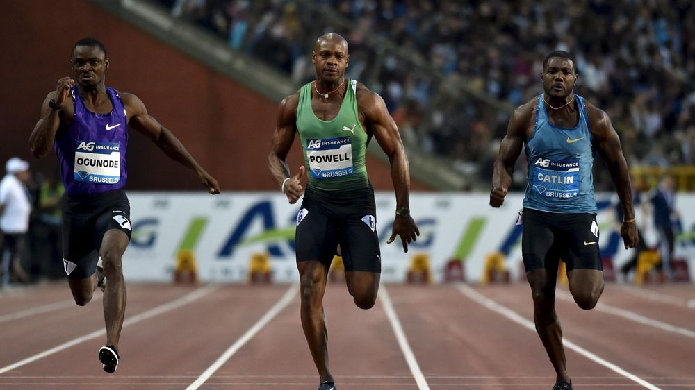 Justin Gatlin of the U.S. (R), Asafa Powell of Jamaica (C) and Femi Ogunode of Qatar compete in the men's 100 metres
