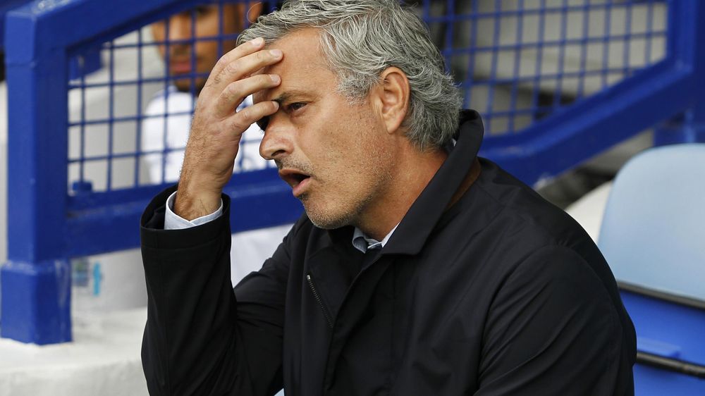 Chelsea manager Jose Mourinho scratches his forehead