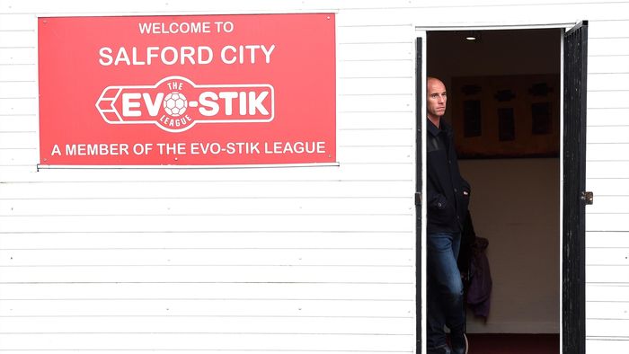 Nicky Butt watches the teams warm up before Manchester United U21's game with Salford City.
