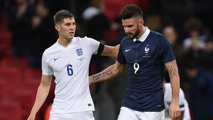 England's John Stones (left) and France's Olivier Giroud (right) in conversation after the final whistle.