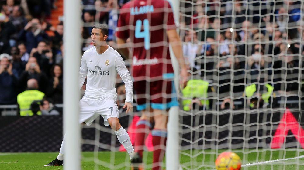 Real Madrid's Portuguese forward Cristiano Ronaldo celebrates after scoring a penalty during the Spanish league football match Real Madrid CF vs Real Sociedad de Futbol at the Santiago Bernabeu stadium in Madrid on December 30, 2015