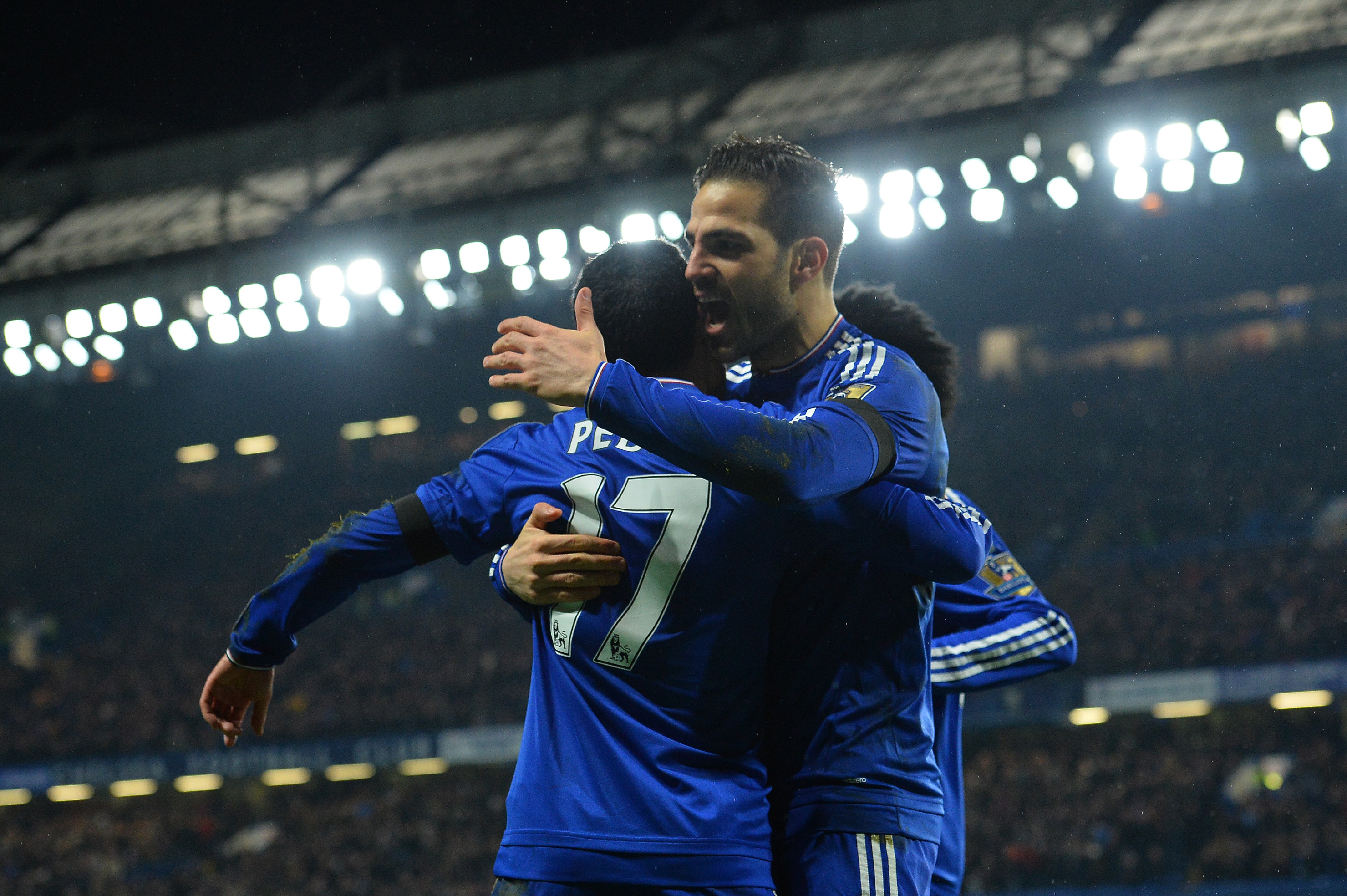 Chelsea's Spanish midfielder Pedro (L) celebrates scoring his team's second goal with Chelsea's Spanish midfielder Cesc Fabregas during the English Premier League football match between Chelsea and Newcastle United at Stamford Bridge in London on February