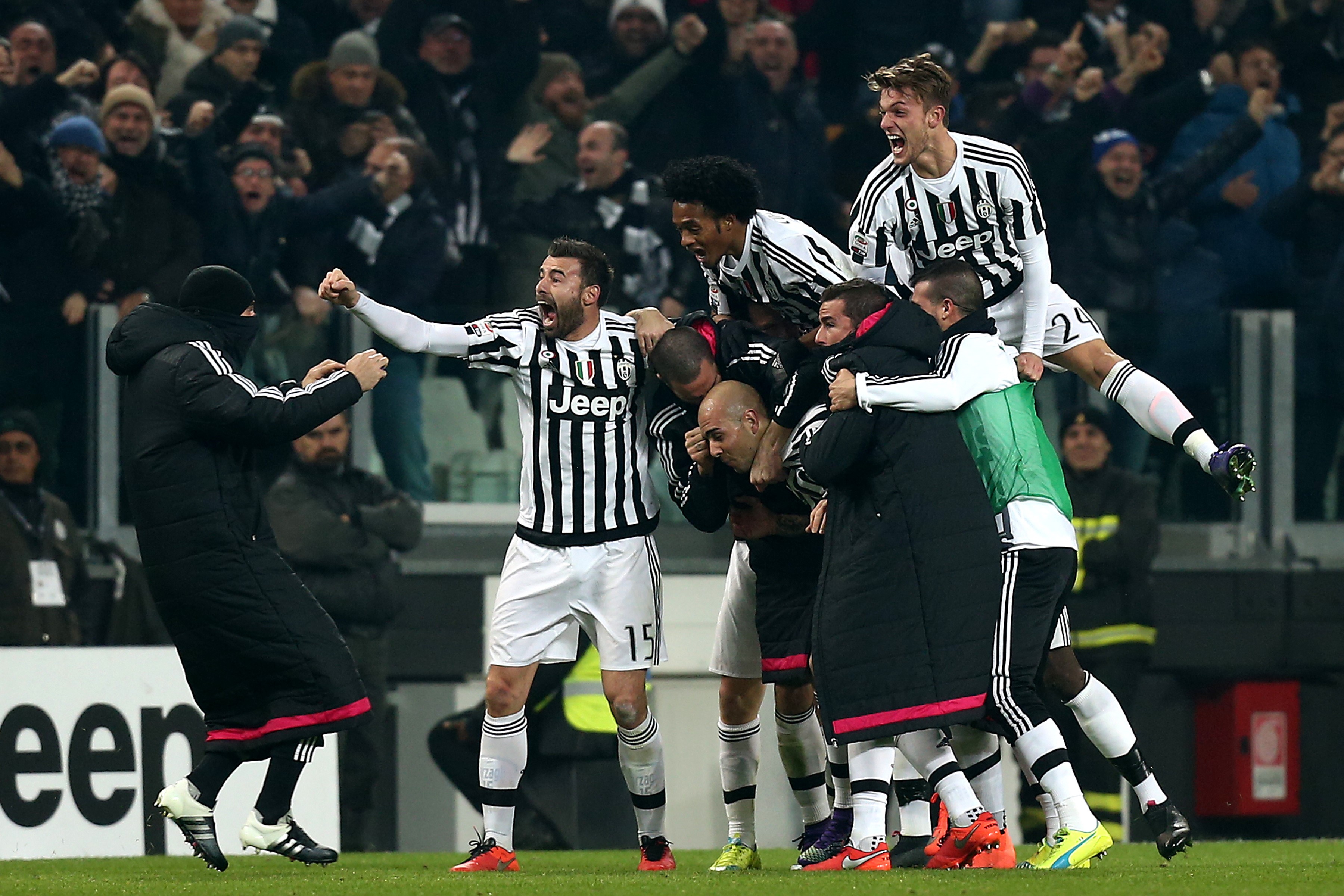 Juventus' forward Simone Zaza (C ) celebrates with teammates after scoring during the Italian Serie A football match Juventus Vs Napoli on February 13, 2016 at the "Juventus Stadium" in Turin.