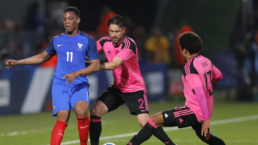 France's Anthony Martial (L), in action with Scotland's Callum Paterson (C) and Jack Hamilton.
