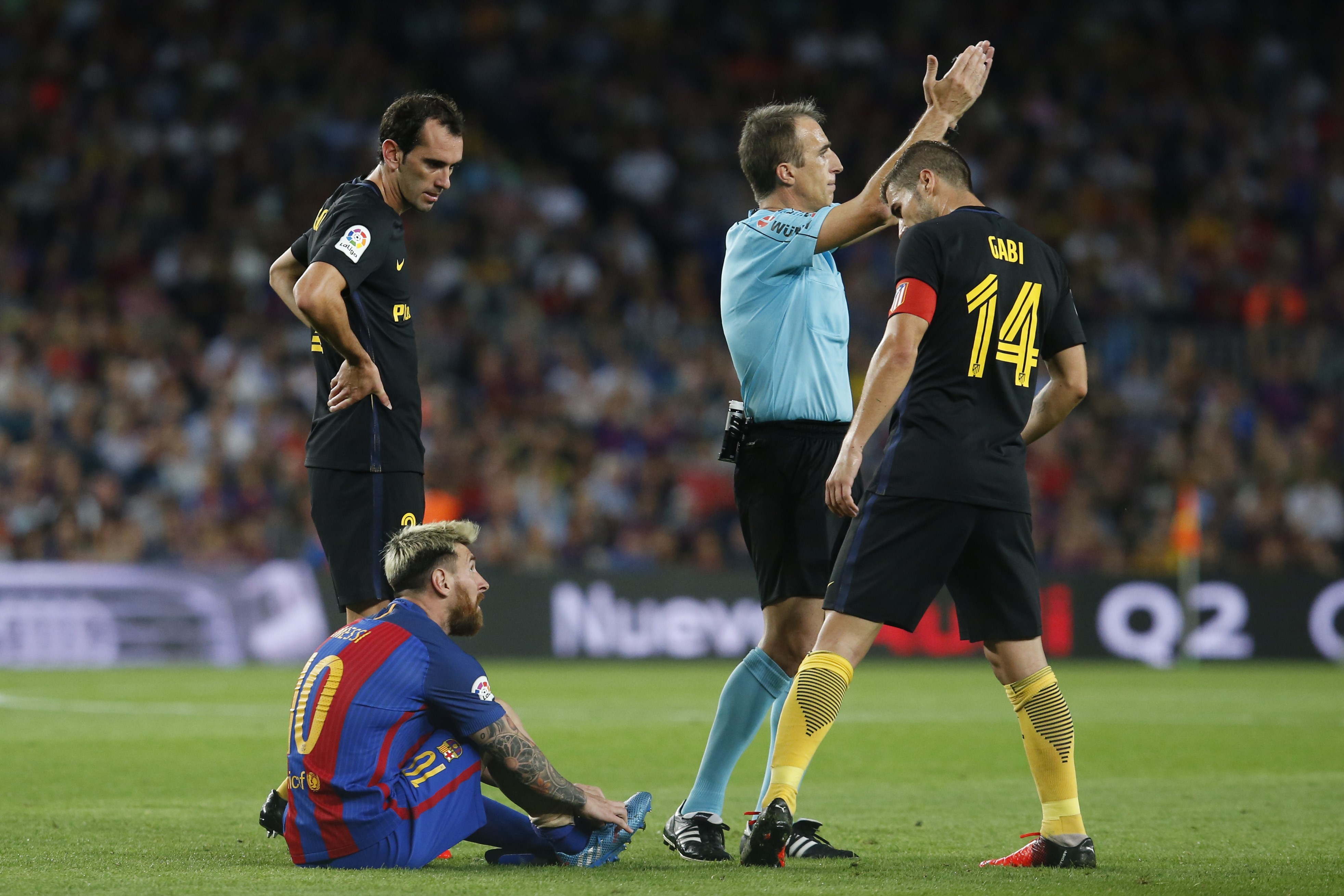 Barcelona's Argentinian forward Lionel Messi sits on the ground