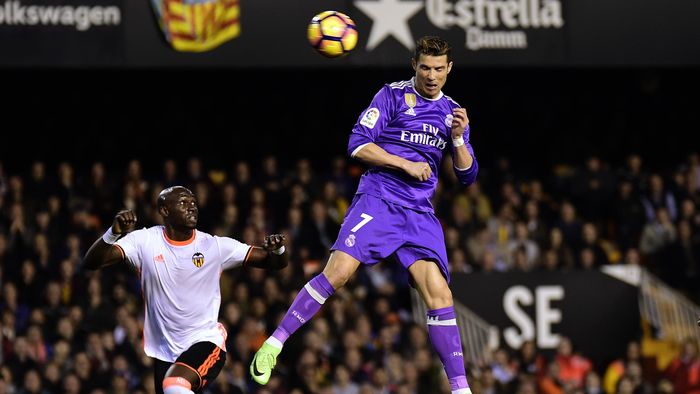 Real Madrid's Portuguese forward Cristiano Ronaldo heads the ball to score a goal during the Spanish league football match Valencia CF vs Real Madrid CF at the Mestalla stadium in Valencia on February 22, 2017.