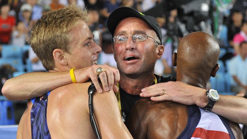 US coach Alberto Salazar (C) hugs Britain's Mo Farah (R) and US athlete Galen Rupp (L) following the men's 5,000 metres final at the International Association of Athletics Federations (IAAF) World Championships in Daegu on September 4, 2011