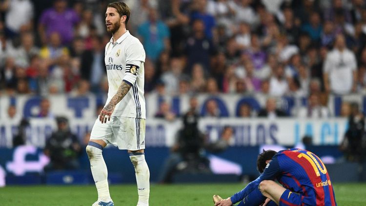 Sergio Ramos of Real Madrid walks past Lionel Messi of Barcelona as he is sent off during the La Liga match between Real Madrid CF and FC Barcelona at Estadio Bernabeu on April 23, 2017 in Madrid, Spain