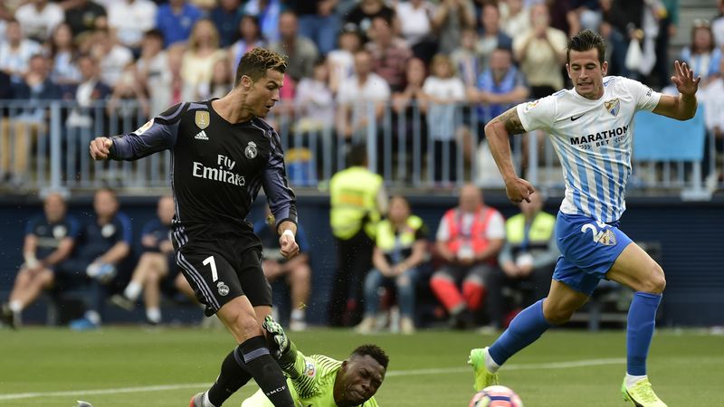 Real Madrid's Portuguese forward Cristiano Ronaldo scores during the Spanish league football match Malaga CF vs Real Madrid CF at La Rosaleda stadium in Malaga on May 21, 2017