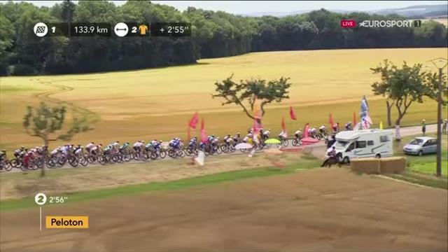 Woman races peloton... on a horse wearing a polka dot hat Woman races peloton... on a horse wearing a polka dot hat