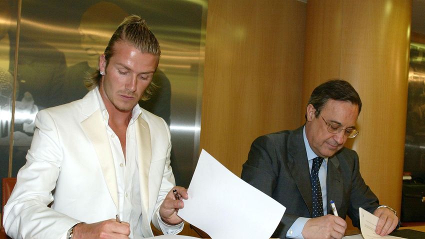 David Beckham (L) signs papers with Real Madrid President Florentino Perez at Santiago Bernabeu Stadium July 1, 2003 in Madrid, Spain. Provided Beckham passes the medical taken today, he will be officially unveiled as a Real Madrid player July 2, 2003 at