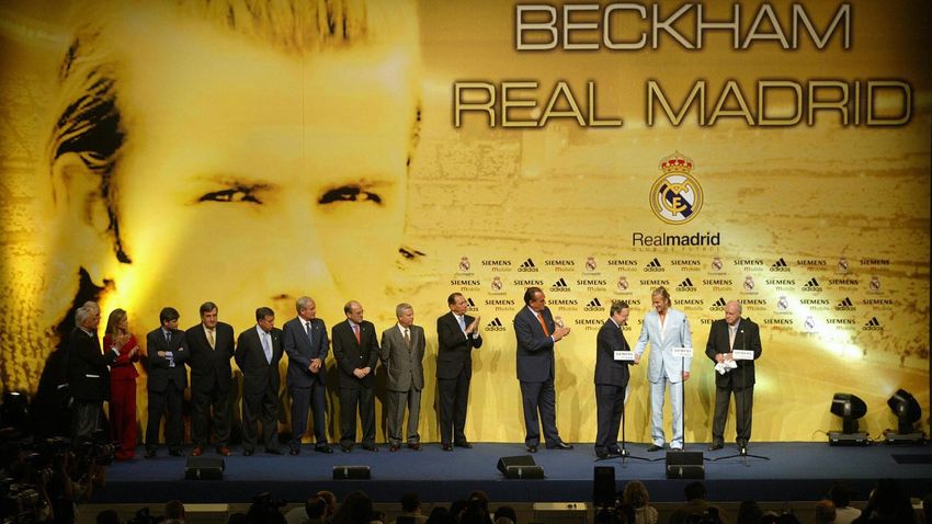 British soccer star, David Beckham (C) shakes hands with Madrid's president Florentino Perez (L) while honorary president Alfredo Di Stefano (R) looks on at Beckhams official presentation as a Real Madrid player at Sport City, Madrid, 02 July 2003