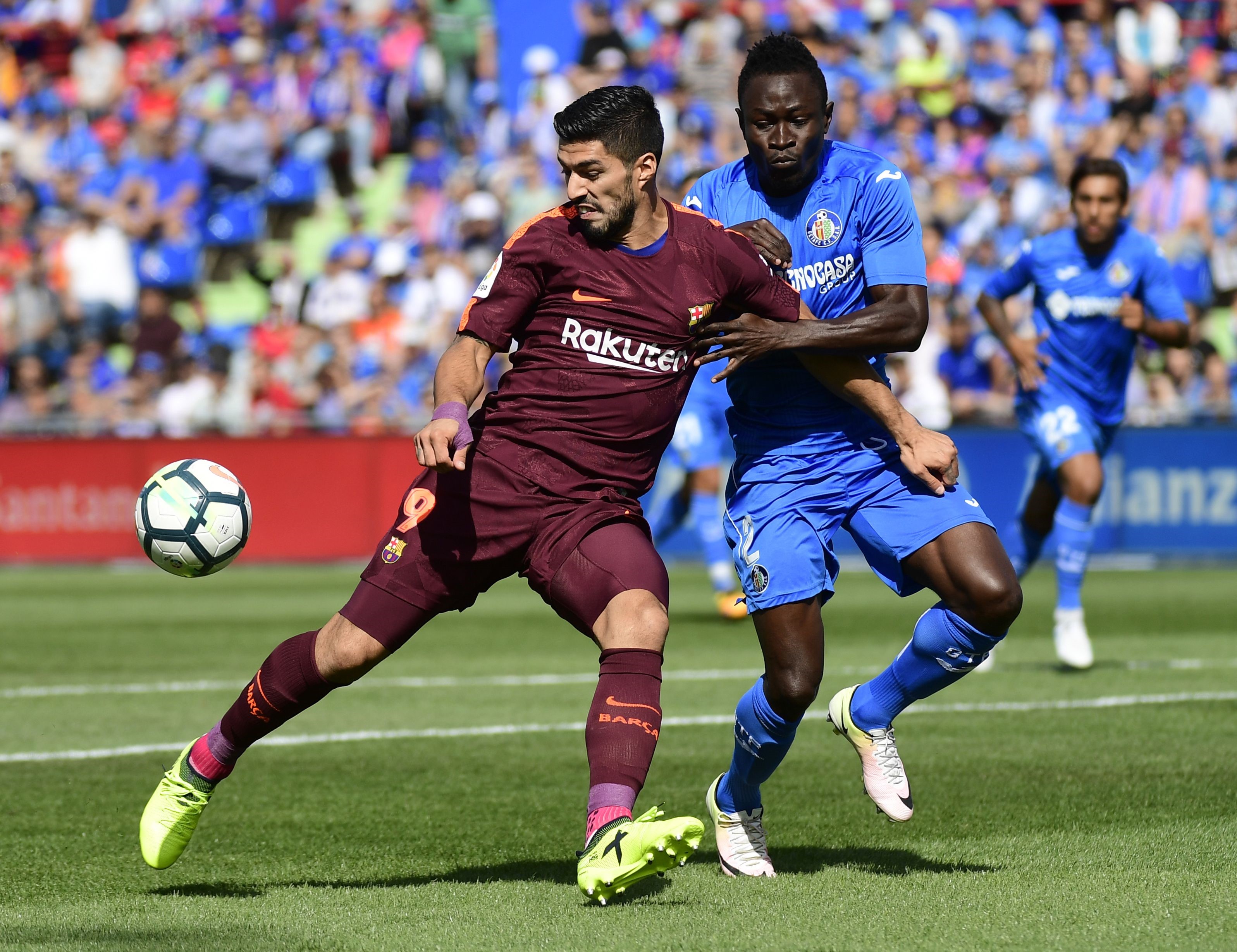 Barcelona's Luis Suarez takes on Dakonam Djene of Getafe