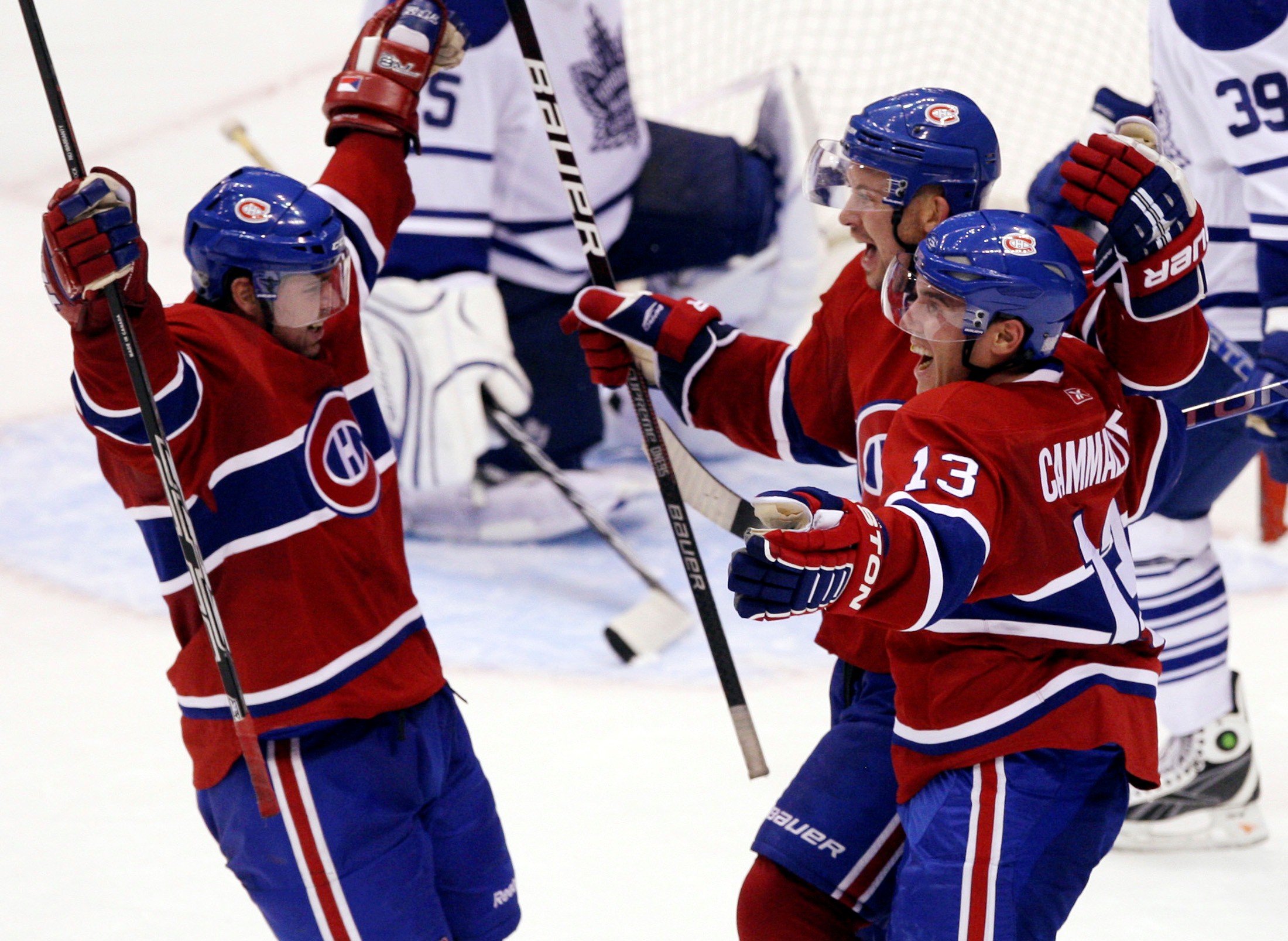 Montreal Canadiens' Josh Gorges celebrates with team-mates Mike Cammelleri (R) and Jarosla Spacek (L) after scoring a game-winning goal against the Toronto Maple Leafs 