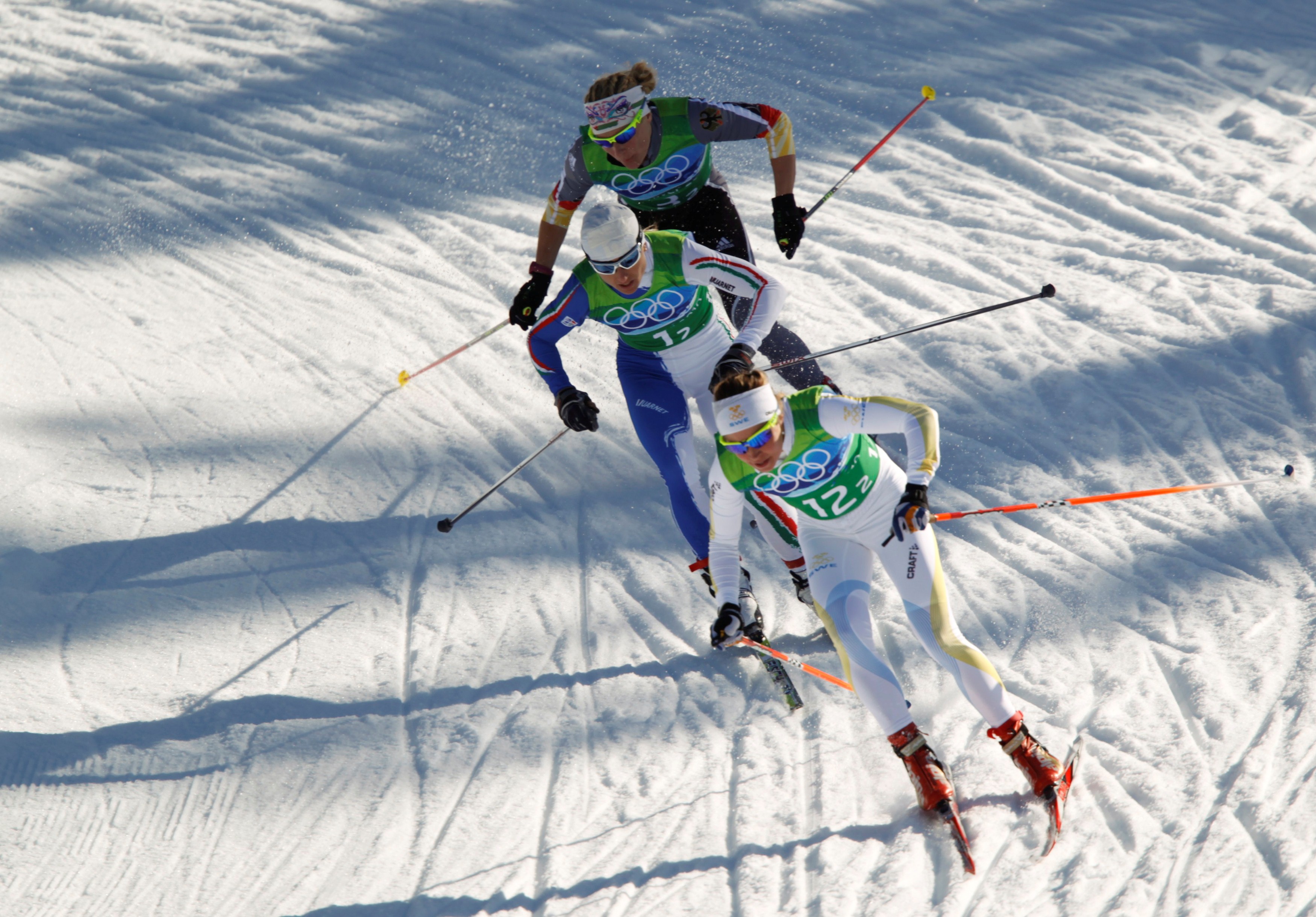 Sweden's Haag, Italy's Follis and Germany's Nystad compete during the Team Sprint cross-country final event at the Vancouver 2010 Winter Olympics in Whistler