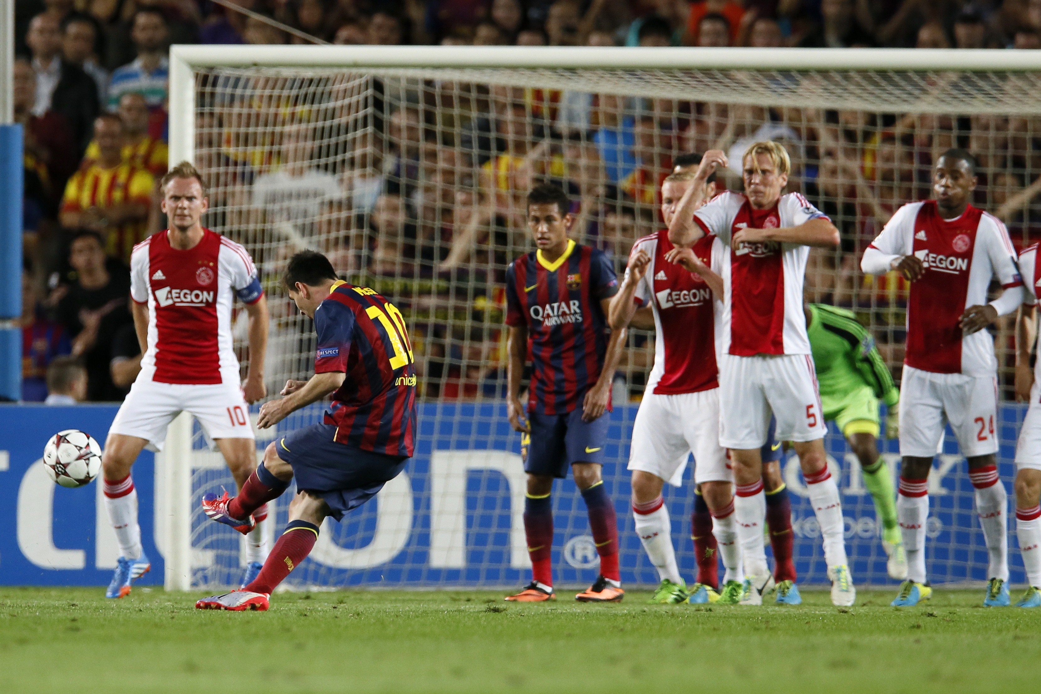 Barcelona's Lionel Messi (2nd L) scores a goal from a direct free kick against Ajax during their Champions League soccer match at Camp Nou stadium in Barcelona September 18, 2013 (Reuters)