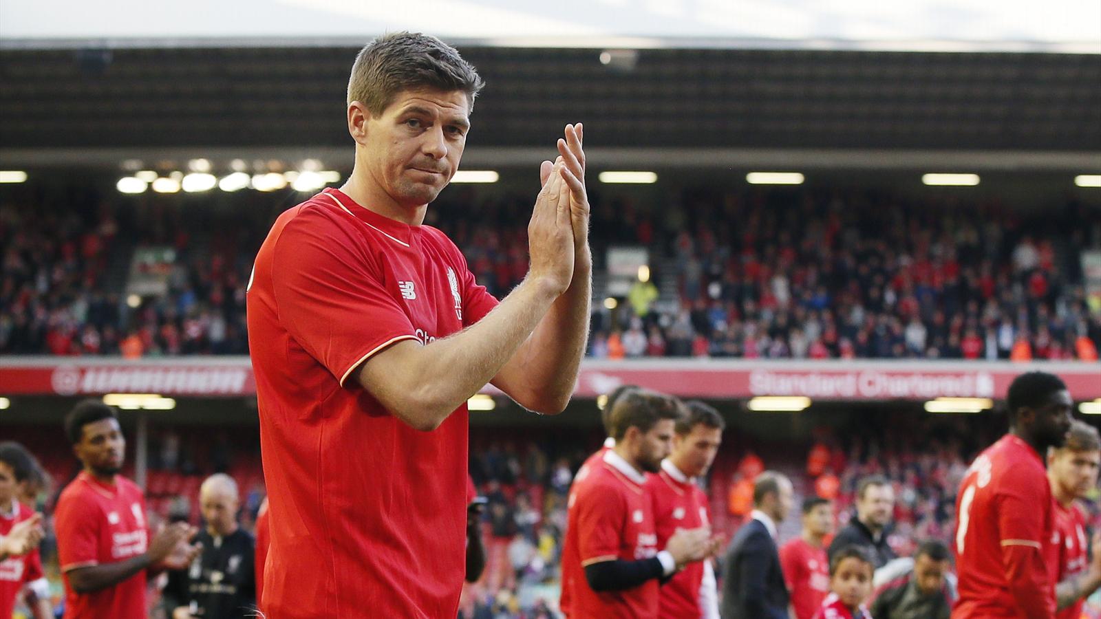 Liverpool's Steven Gerrard applauds fans as he walks on the pitch with his family after his final game at Anfield