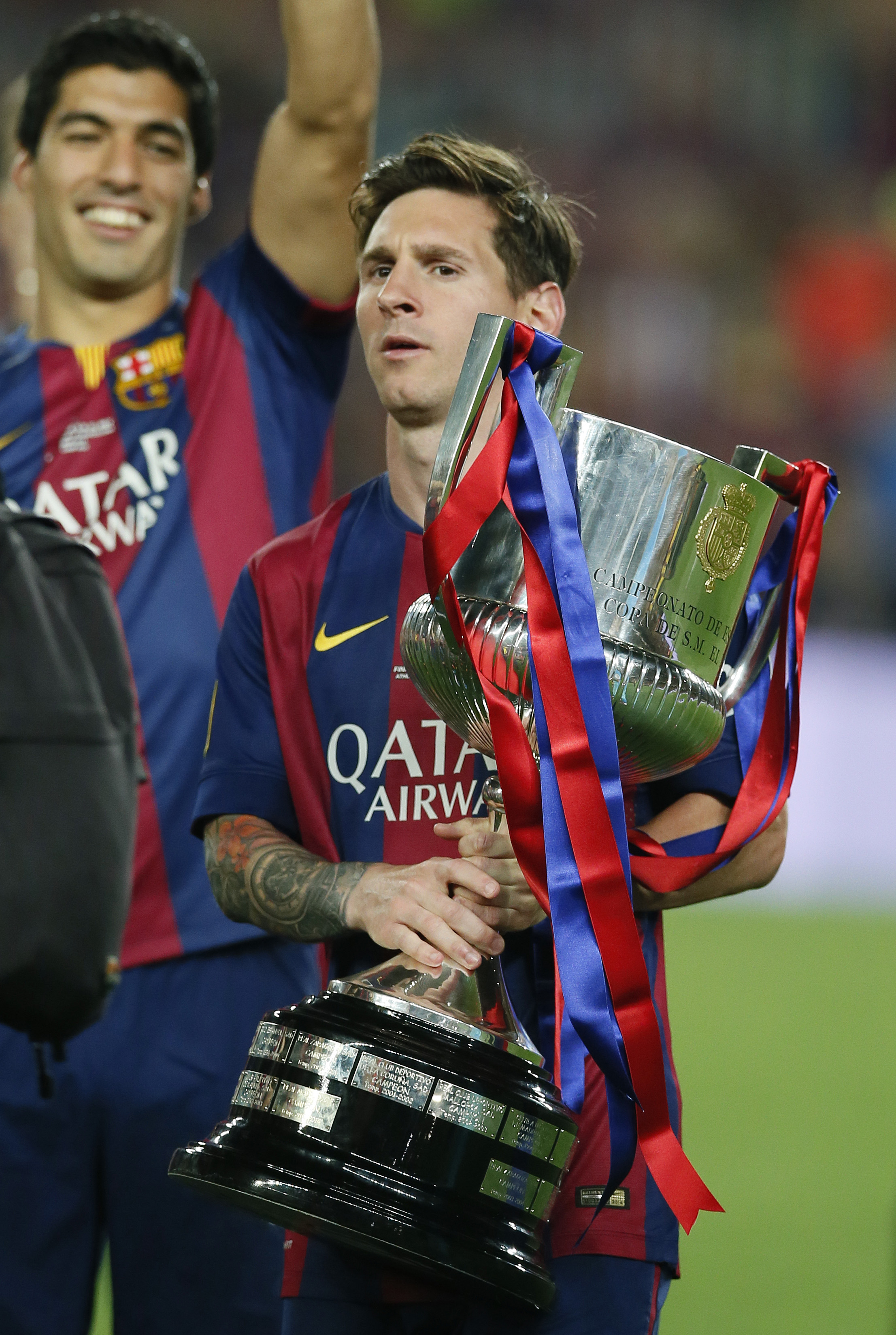 Barcelona's Lionel Messi and Luis Suarez celebrate with the trophy after winning the Spanish King's Cup Final 