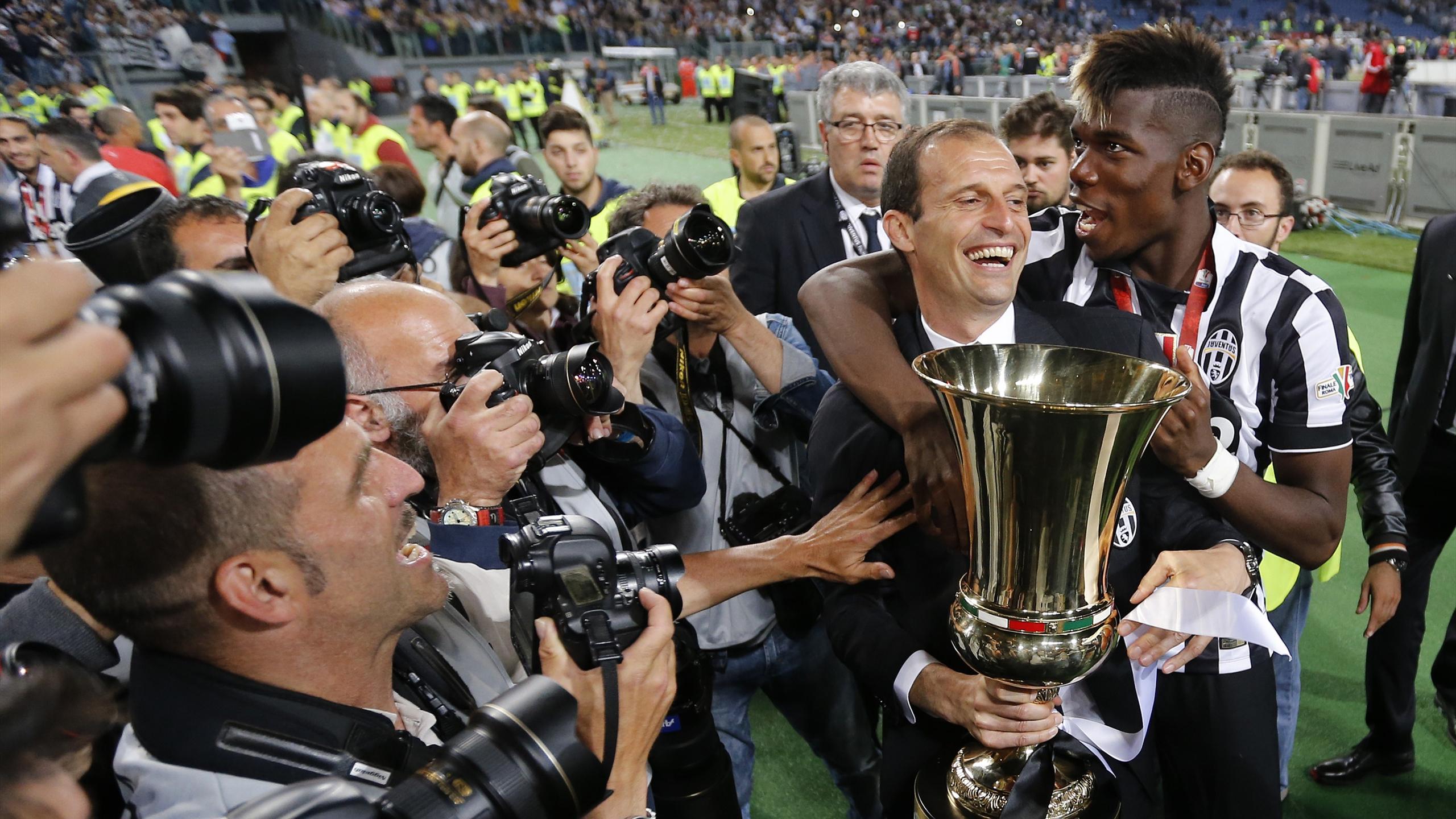 Juventus coach Massimiliano Allegri and Paul Pogba celebrate with the trophy after winning the Italian Cup Final