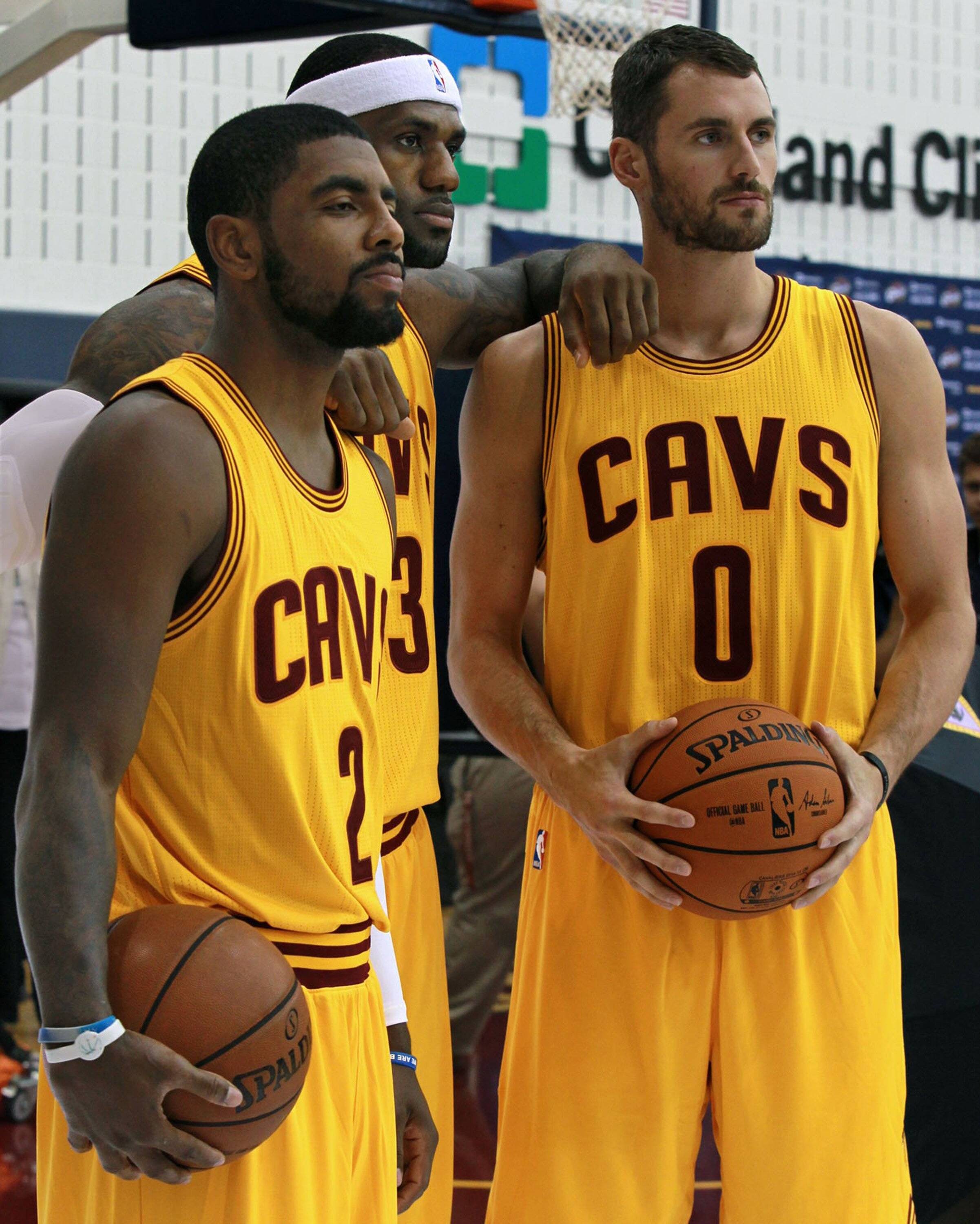 Kyrie Irving (L), LeBron James and Kevin Love (R) pose for the Cleveland Cavaliers media day