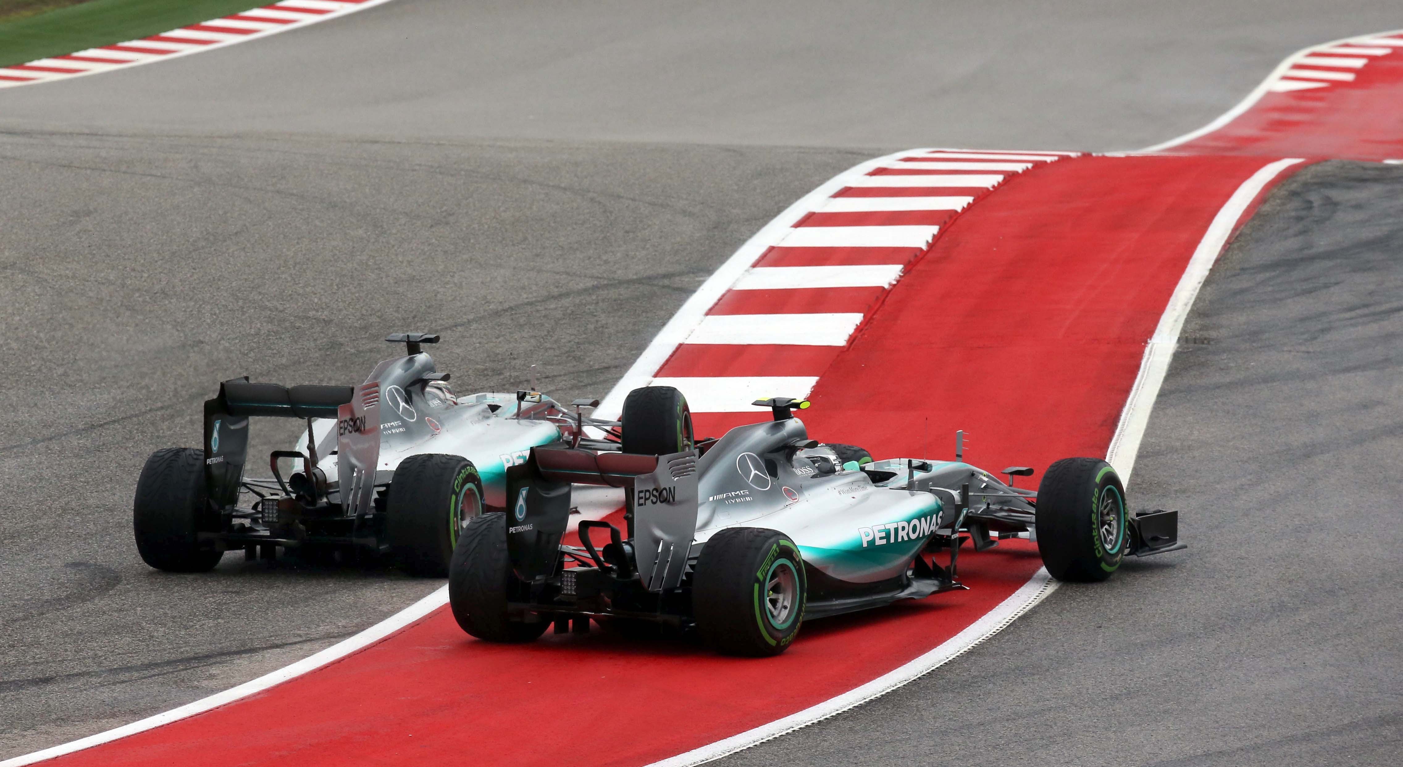 Lewis Hamilton (left) pushes Nico Rosberg wide on the first corner