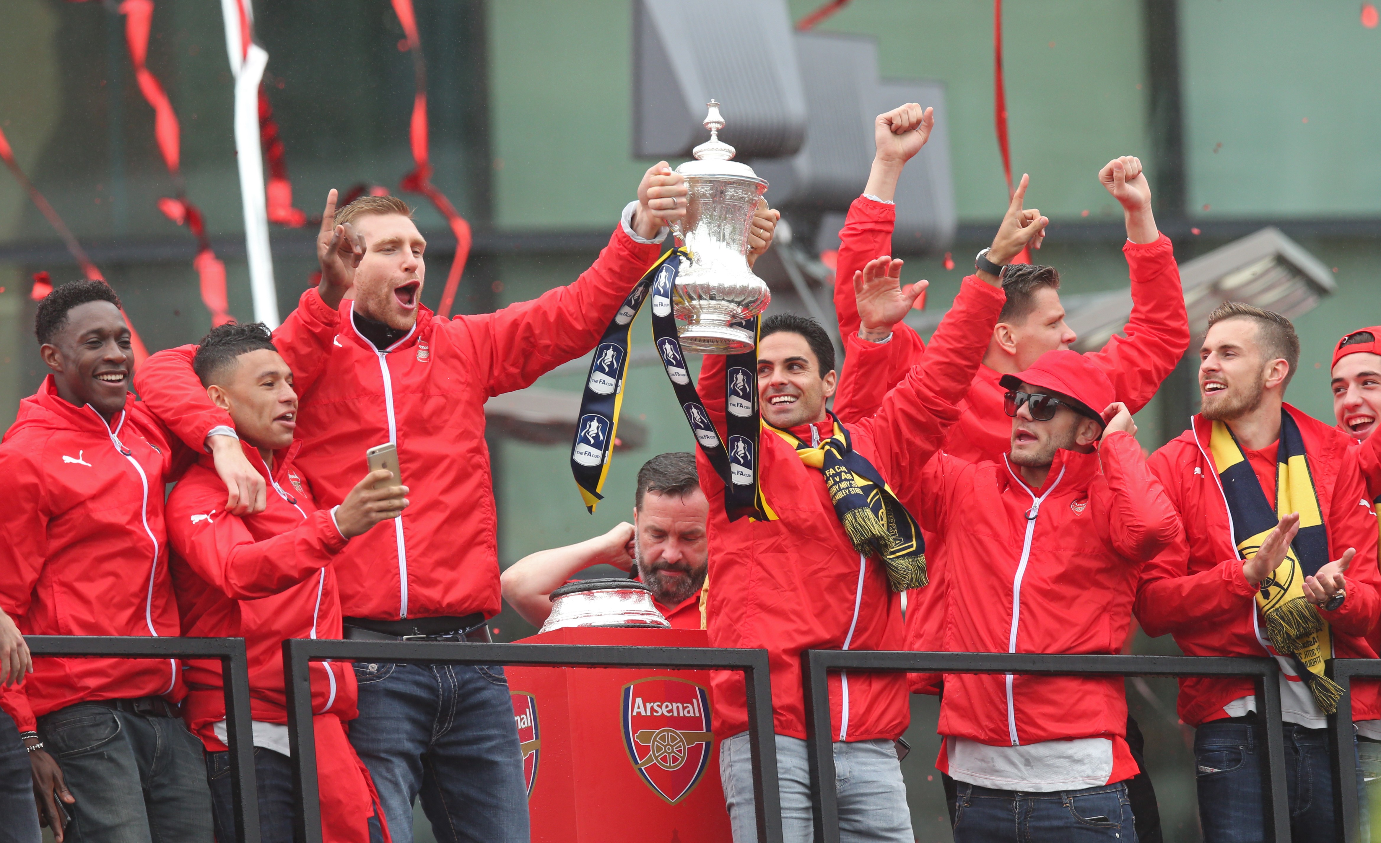 Arsenal's Danny Welbeck, Alex Oxlade Chamberlain, Per Mertesacker, Mikel Arteta, Jack Wilshere and Aaron Ramsey celebrate during the parade