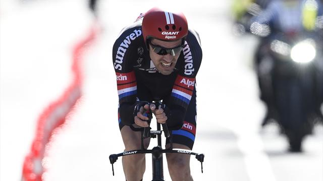 Dumoulin wins opening time trial to take pink