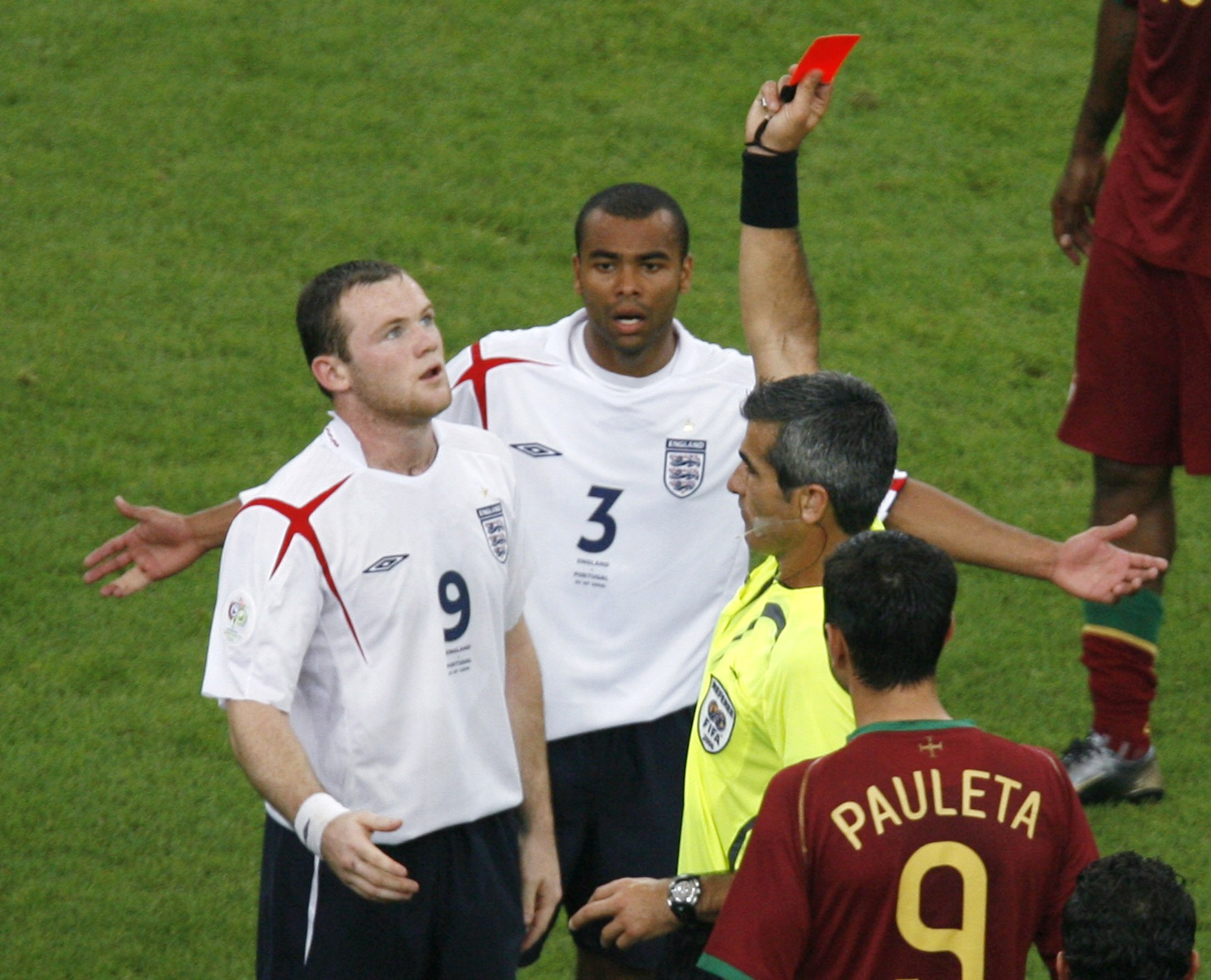 Referee Horacio Elizondo of Argentina shows England's Wayne Rooney a red card