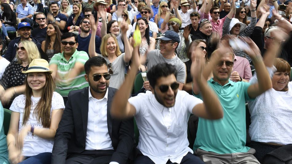 General view as spectators perform a mexican wave on centre court before the start of play