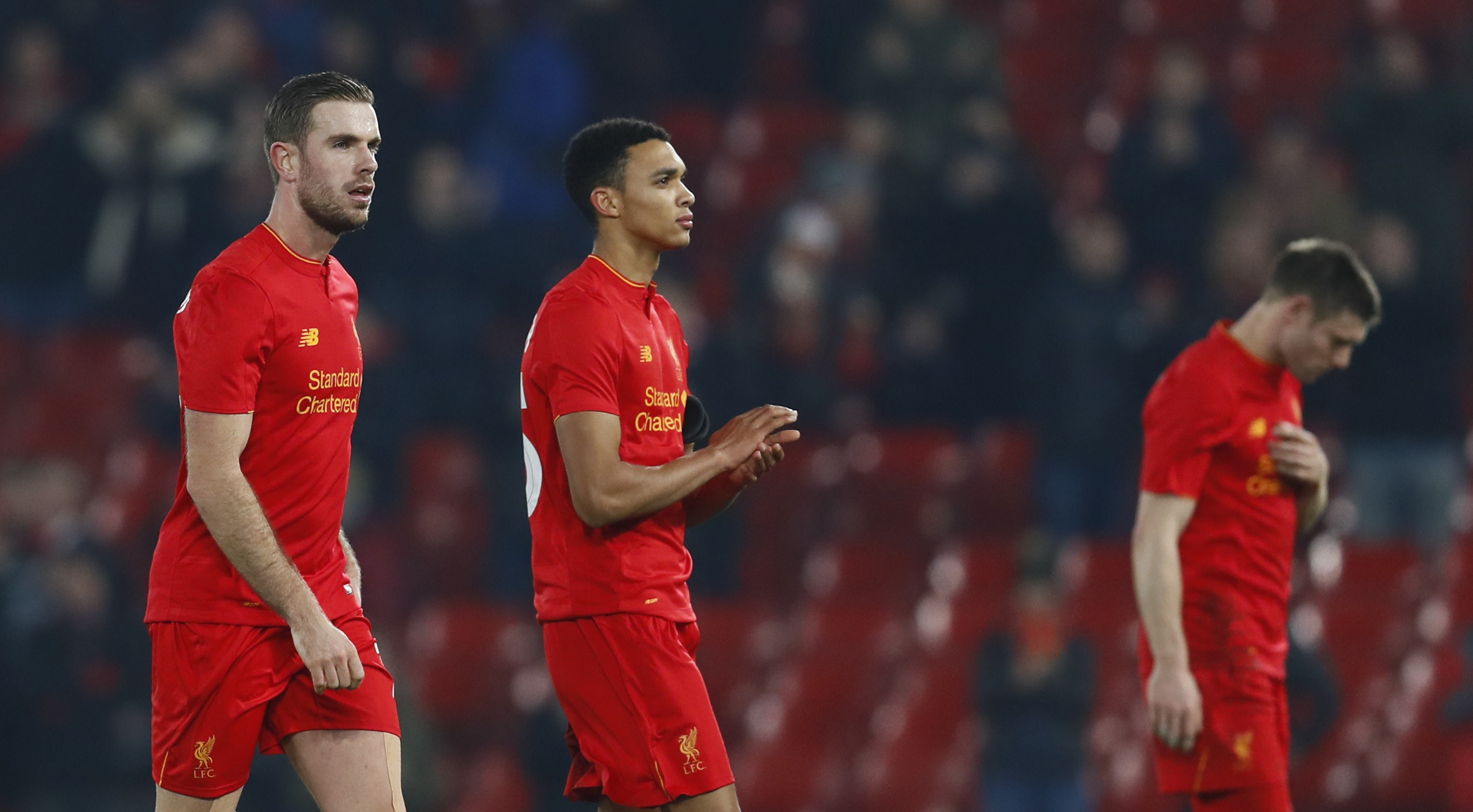 Liverpool's Jordan Henderson, Trent Alexander-Arnold and James Milner look dejected