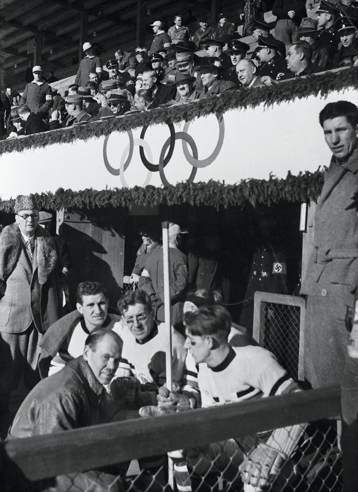 Adolf Hitler sits in the stands as the British team pose for a photo (IOC)