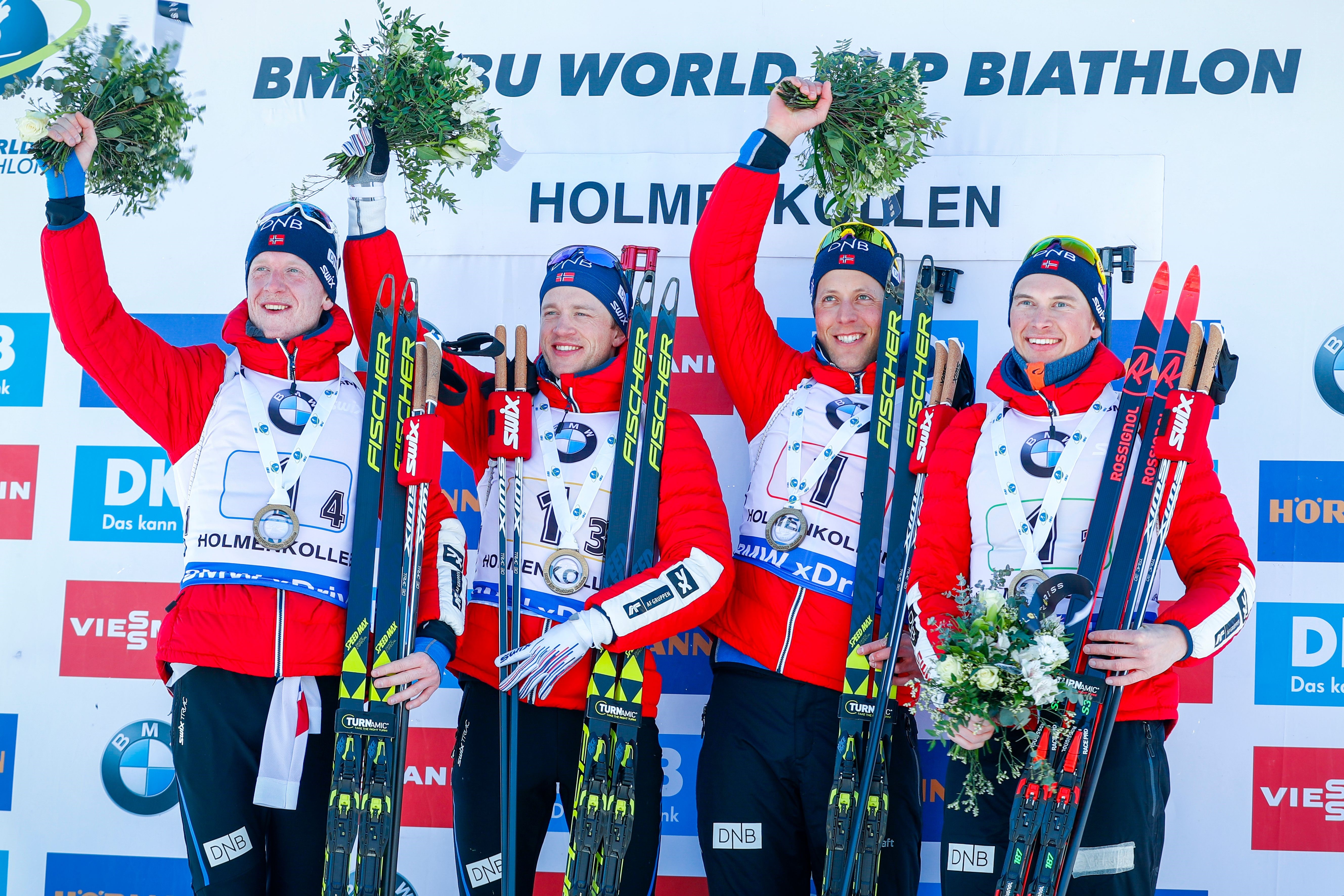 (L-R) Norway's Johannes Thingnes Boe, Tarjei Boe, Lars Helge Birkeland and Henrik L'abee-Lund pose on the podium after winning the IBU Biathlon World Cup Men's 4x7,5 km Relay event in Holmenkollen, Oslo, on March 18. 2018.
