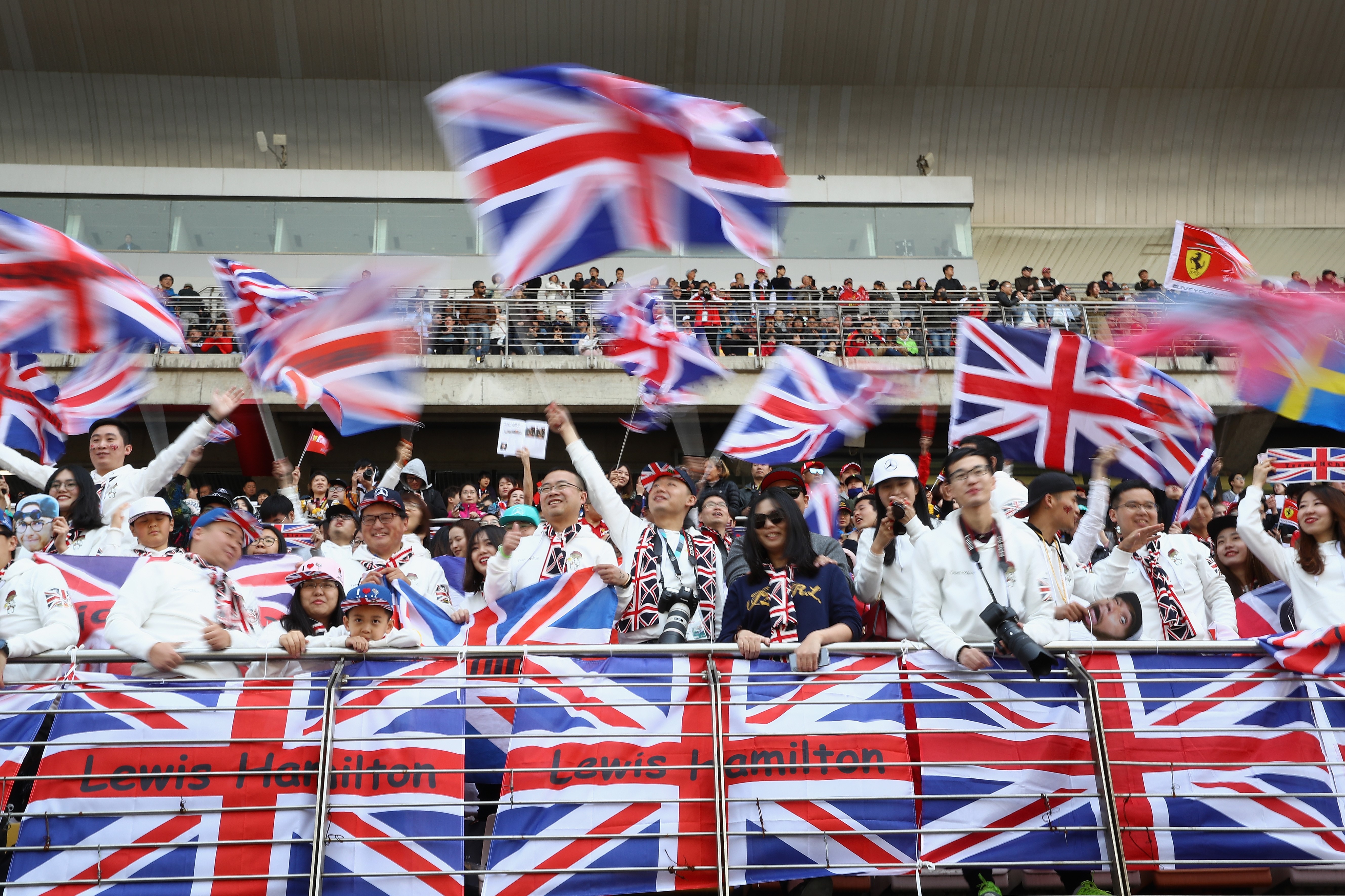 Lewis Hamilton of Great Britain and Mercedes GP fans wave flags before the Formula One Grand Prix of China at Shanghai International Circuit on April 15, 2018