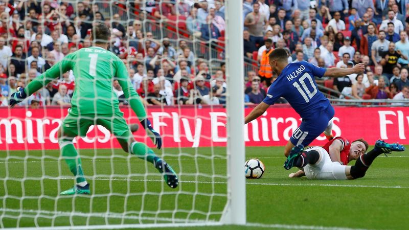 Manchester United's Phil Jones brings down Eden Hazard of Chelsea