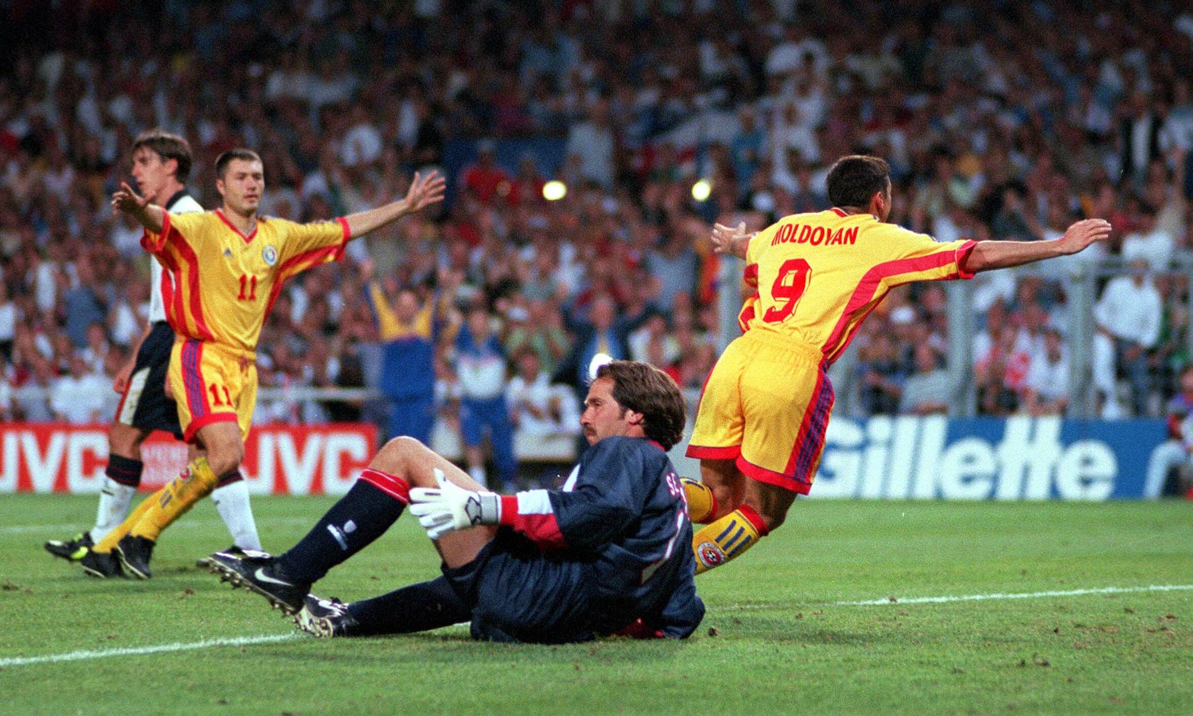 Romania's Viorel Moldovan (9) celebrates after scoring his sides first goal, beating England's David Seaman.