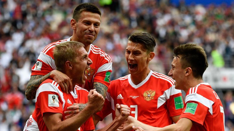 Russia's midfielder Yuri Gazinskiy (L) celebrates scoring the opening goal with his teammates during the Russia 2018 World Cup Group A football match between Russia and Saudi Arabia at the Luzhniki Stadium in Moscow on June 14, 2018
