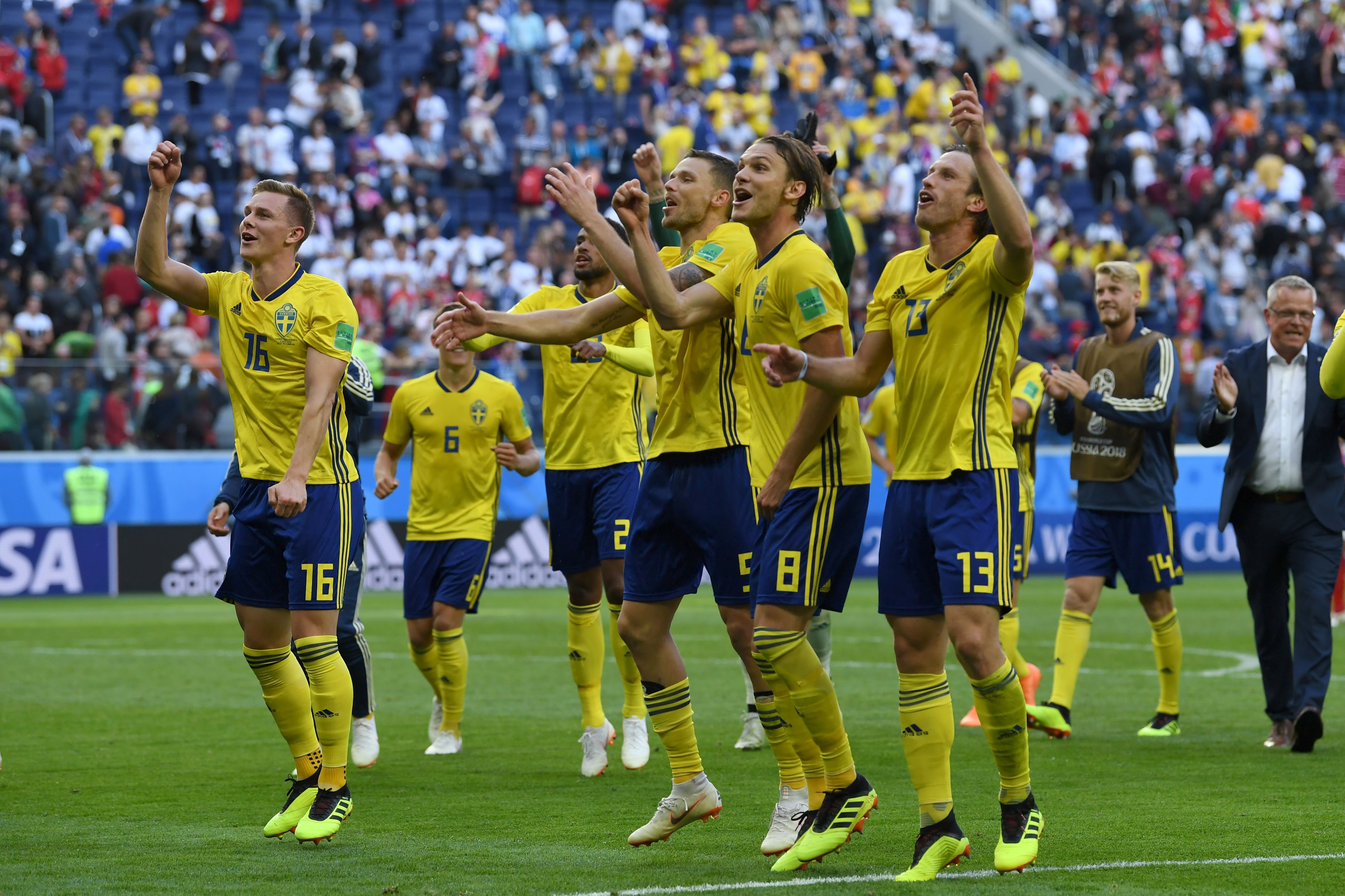 Sweden's players celebrate their victory at the end of the Russia 2018 World Cup round of 16 football match between Sweden and Switzerland at the Saint Petersburg Stadium in Saint Petersburg on July 3, 2018.